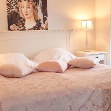 Photo of bed in hotel room illustrates living and eating